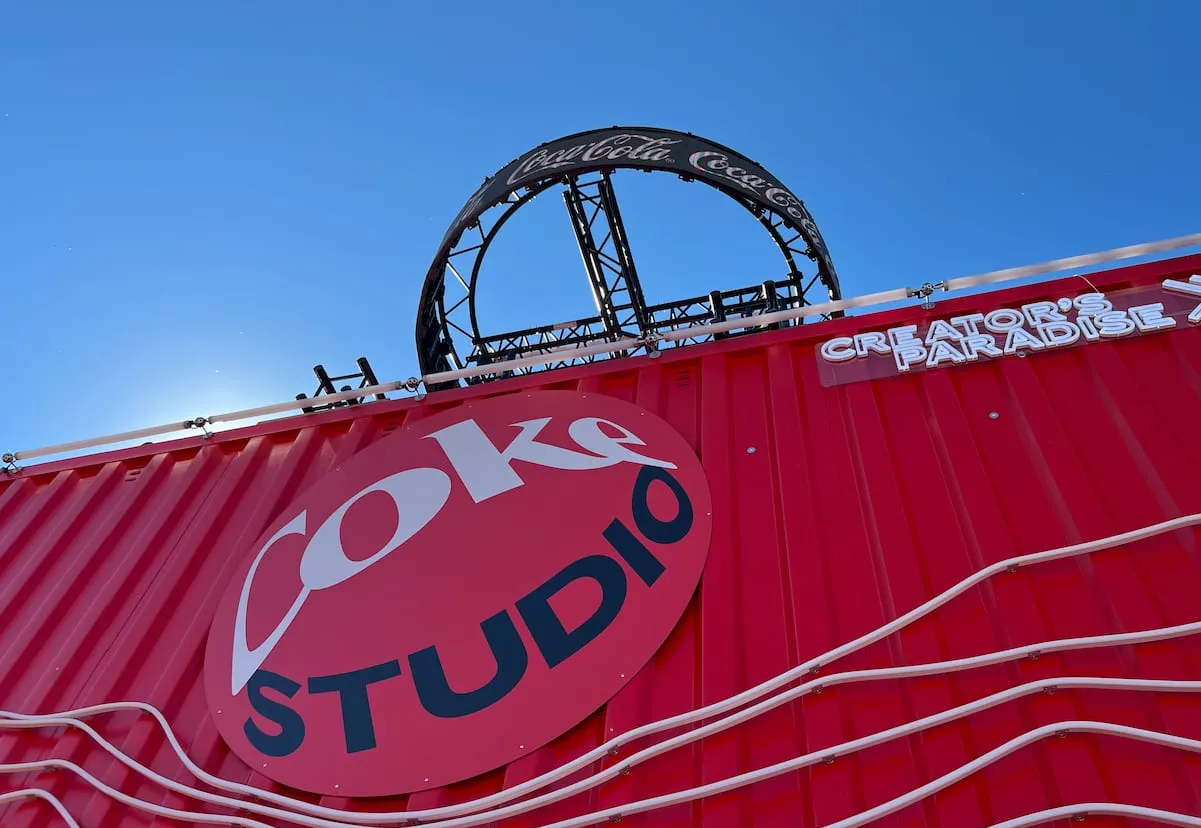 Red container facade with the Coke Studio logo, a Coca-Cola truss ring and Creator's Paradise lettering