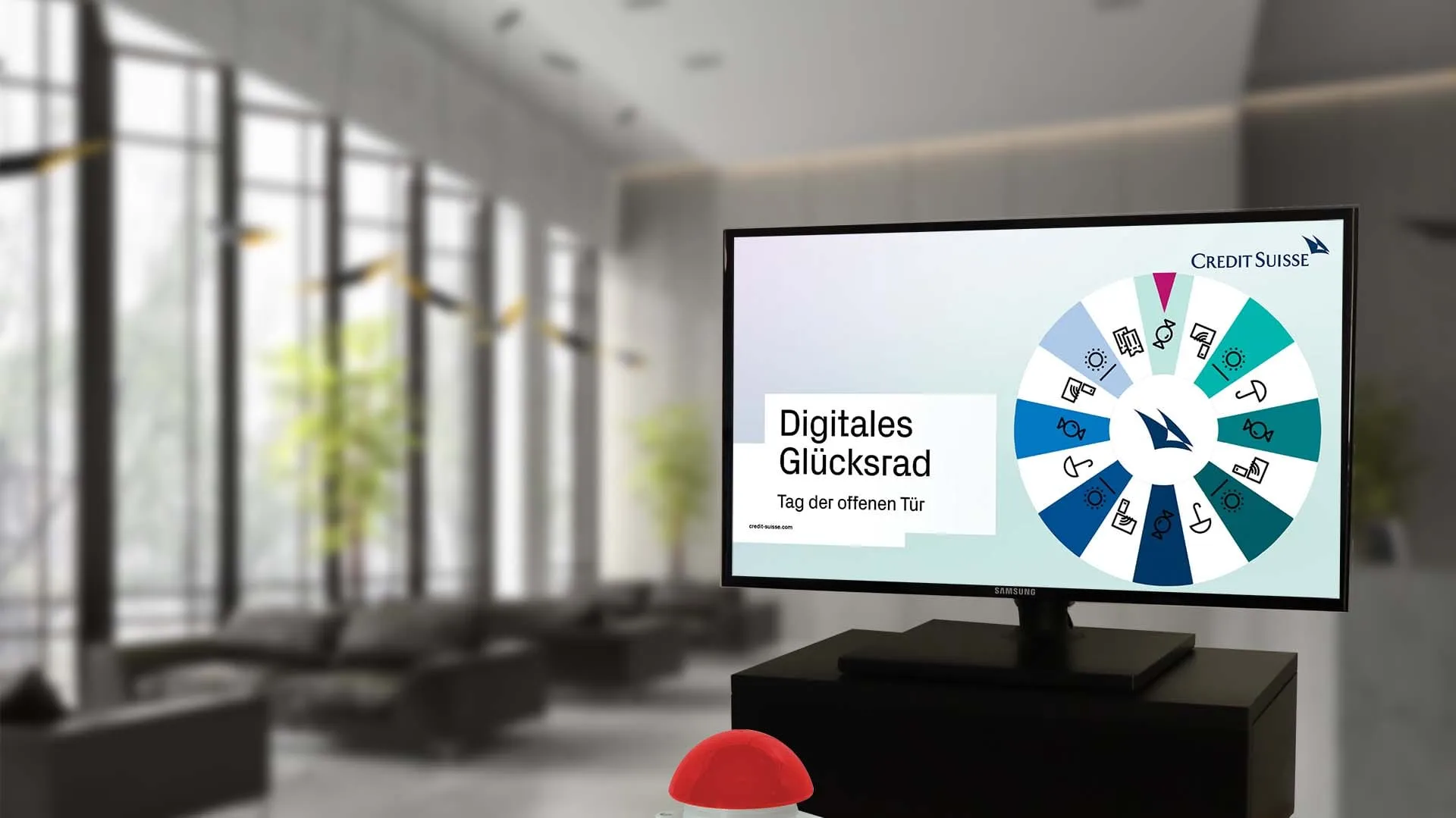 Screen with the digital Glücksrad of Credit Suisse for the open day, a lobby behind it