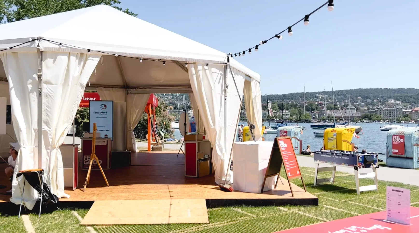 Weisses Zelt mit Bildschirm «Deutschland Das Reiseland», Feel-Good-Aufsteller und Tischfussball am Zürichsee