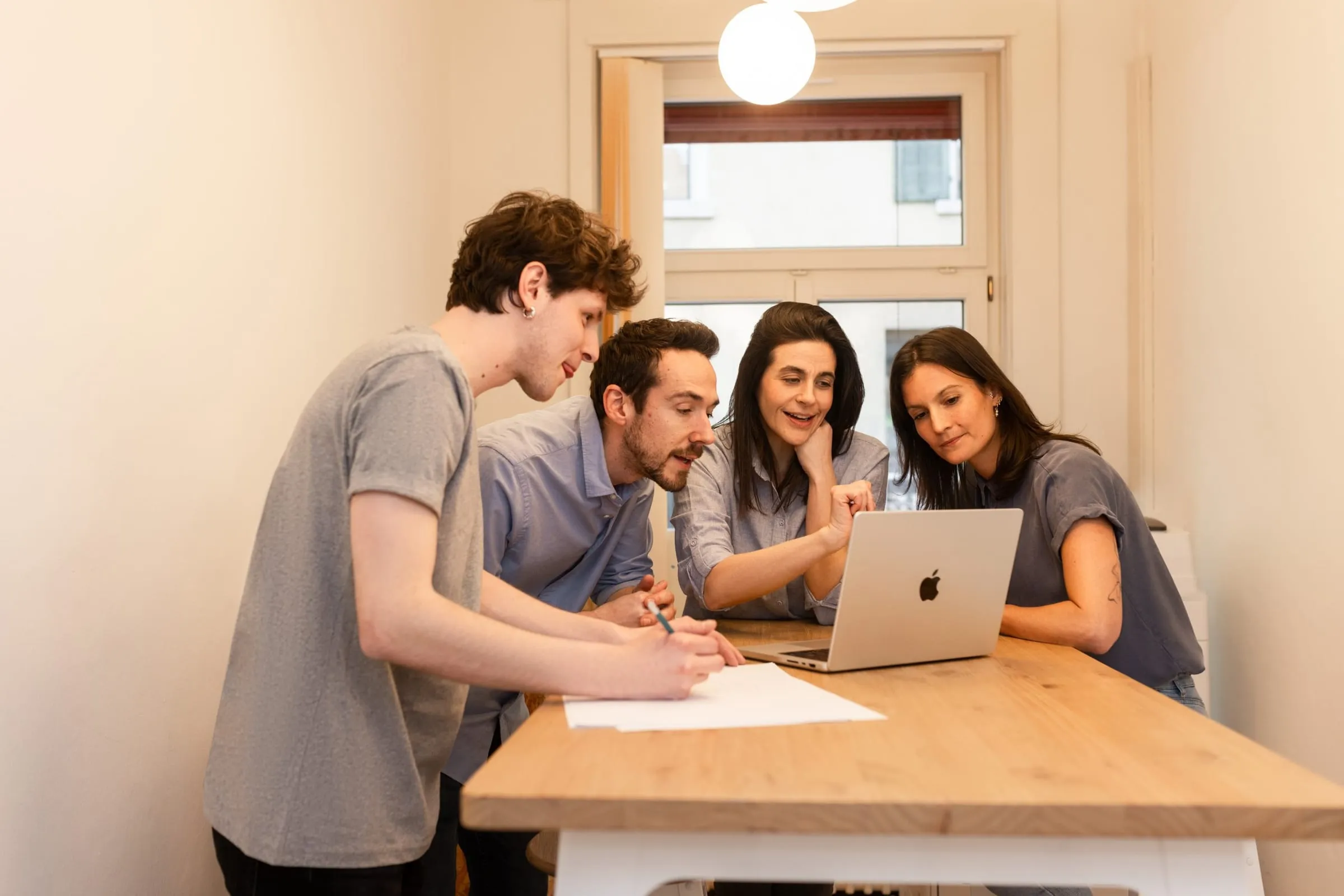 The made team discussing a project at a standing table